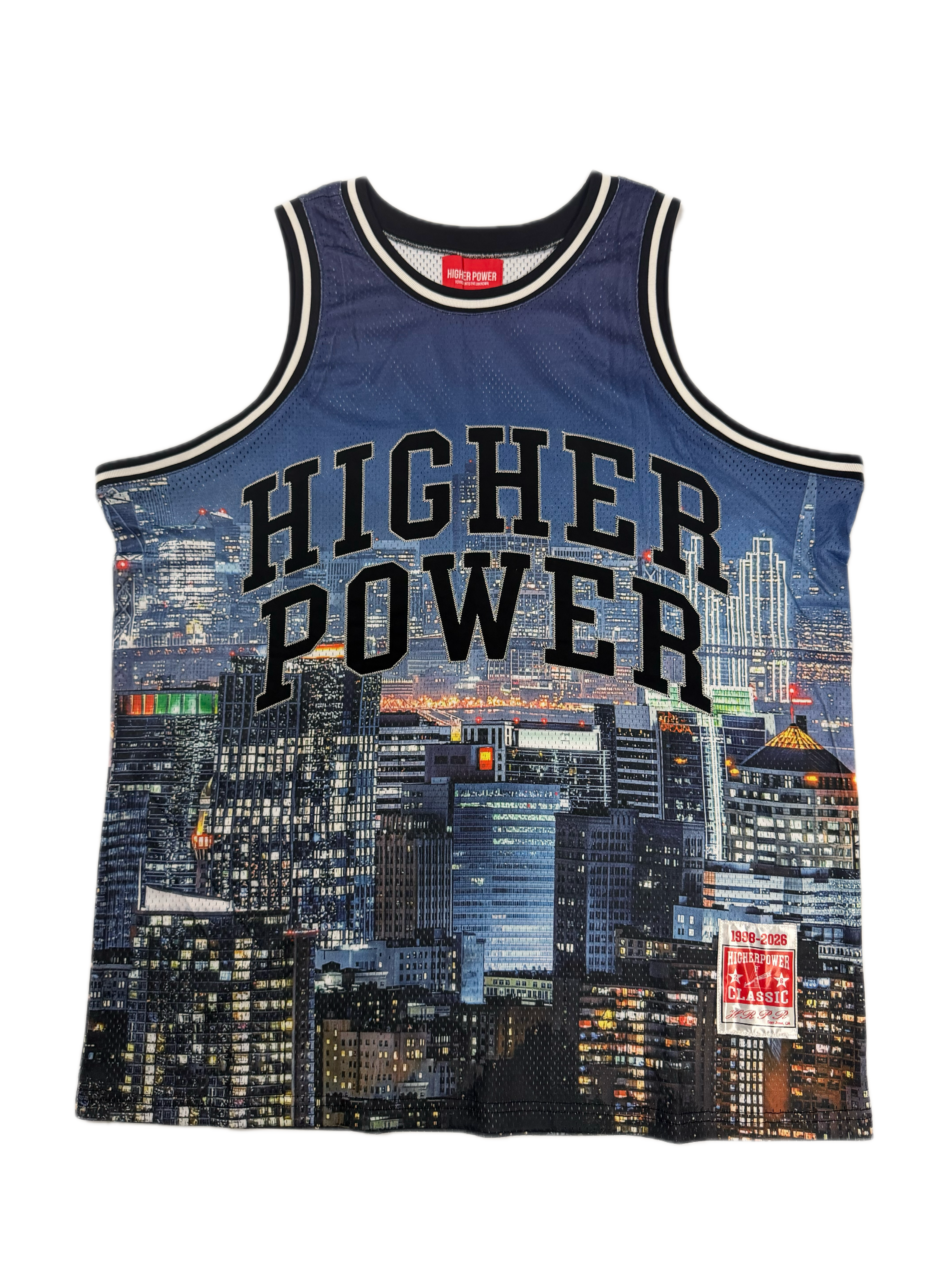 A blue mesh basketball jersey with 'HIGHER POWER' printed in black arched text across the front, featuring a city skyline graphic and a red Mitchell & Ness neck label.
