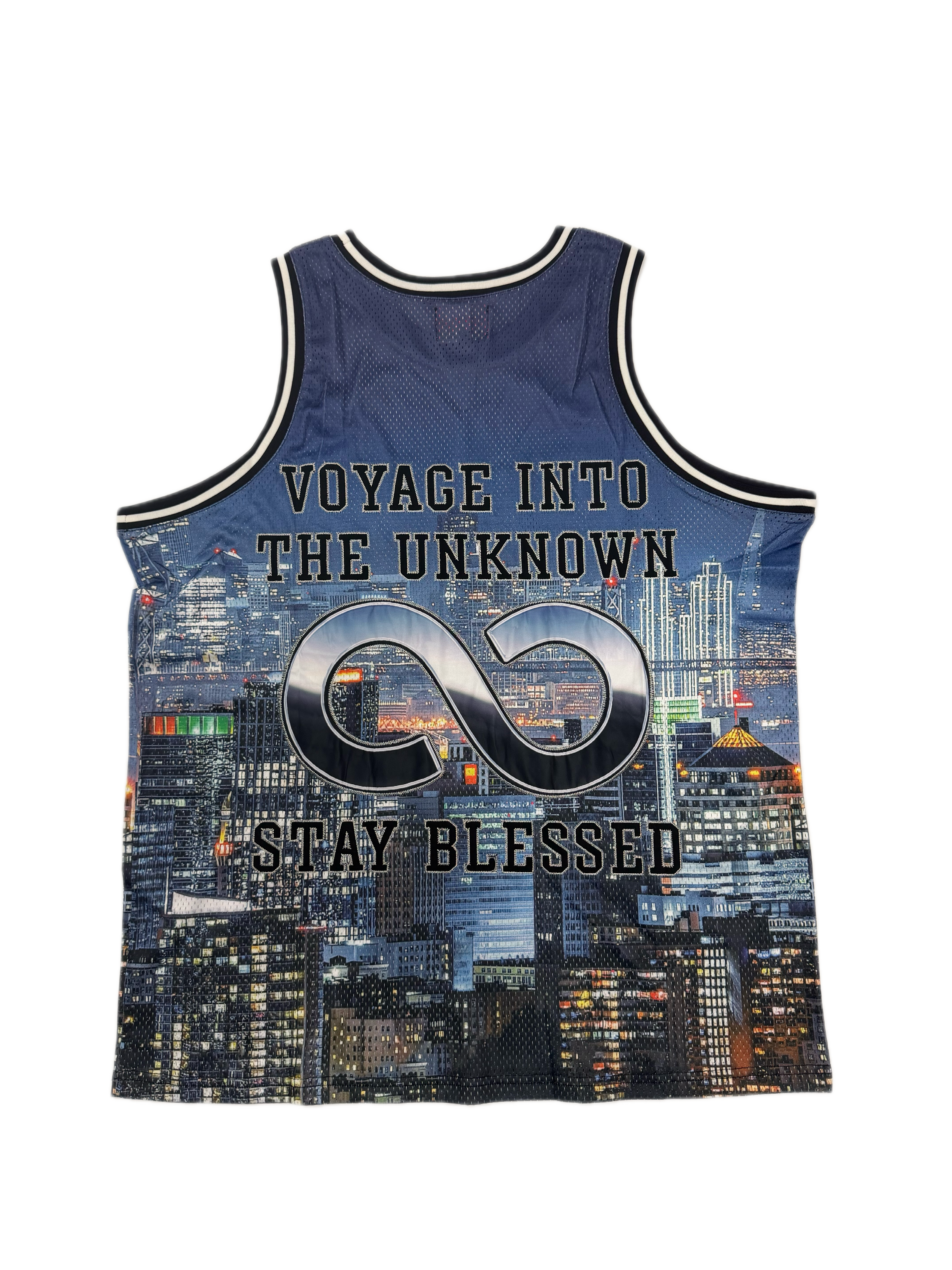 A sleeveless athletic tank top with a navy blue and black city skyline print, featuring the text 'VOYAGE INTO THE UNKNOWN' and 'STAY BLESSED' with a large infinity symbol on the front.